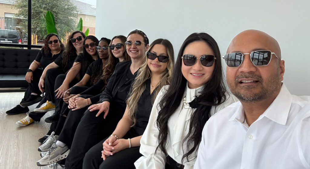 Team photo of Vision Source Katy Ranch wearing sunglasses from their optical department
